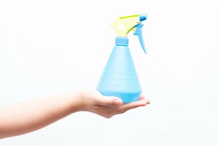 Asian woman holding a water sprayer for ironing, isolatedの写真素材