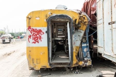 A wreckage of passenger train from train yard on a sunny dayの写真素材
