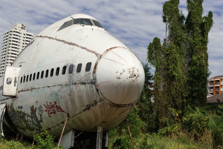 Front of white airplane wrekage, taken on a sunny day, useful for plane safety, pilot, flights, air craft, aero space industry, travel, holiday, insurance related conceptsの写真素材