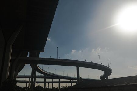 Silhouette of highway ramps on a sunny day, useful for construction, engineering, transportation,...