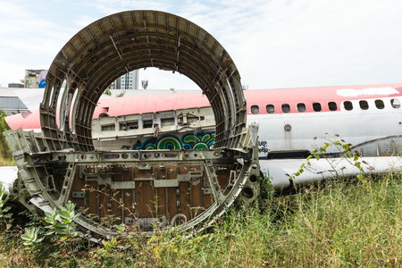 Plane fuselage wreckage sitting on the ground, taken on a sunny day, useful for plane safety, pilot, flights, air craft, aero space industry, travel, holiday, insurance related conceptsの写真素材