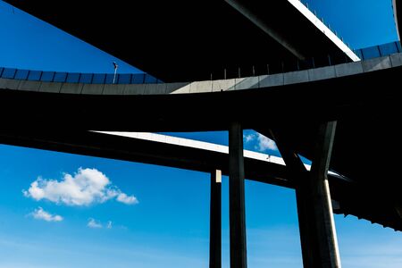 Silhouette of highway ramps on a sunny day, useful for construction, engineering, transportation,...