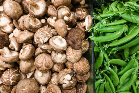 Raw mushroom and green pea in supermarket, a healthy diet, useful for food and vegetable conceptの写真素材
