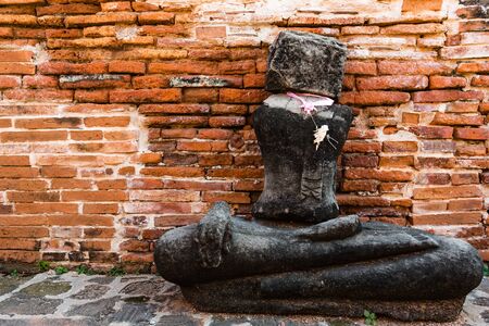 Broken buddha statue, taken outdooor in afternoon, useful for religious and faith conceptsの写真素材