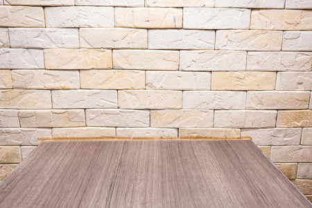 Brown yellow brick with wooden table background, useful for design, background, business conceptsの写真素材