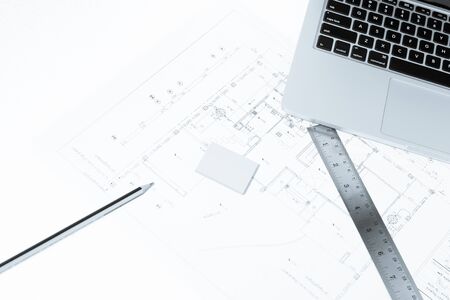 Pen, drawing rulers, and notebook over house construction blueprint with blue tone effect, useful for construction, business, architecture, engineering, insurance background conceptsの写真素材