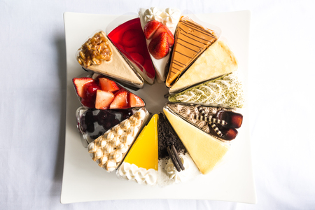 Topdown view of cakes, strawberry, cheese, chocolate, blue berry, coffee cakes taken outdoor with natural lightsの写真素材