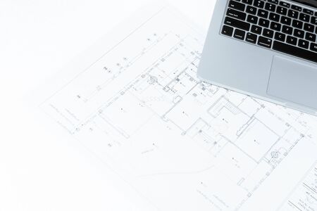 notebook over house construction blueprint with blue tone effect, useful for construction, business, architecture, engineering, insurance background conceptsの写真素材