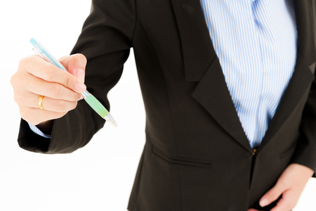 Young confident asian woman, orange safety hat, black suit, blue shirt on white using pen. For engineering, construction, architecture, business man concepts.の写真素材