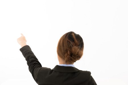 Back of Young attractive confident Asian female business woman in suit blue shirt sit on chair relaxing with finger point on white background. For cooperate success woman career visual communicationの写真素材