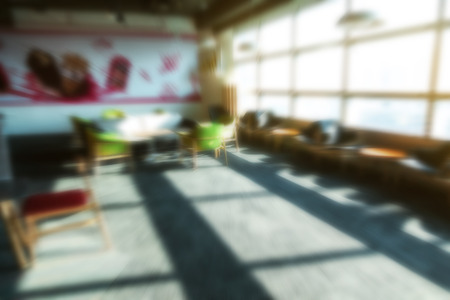 blur office background coffee break area with resting comfortable chair, coffee maker, fridge, taken indoor in morning with sun shining from window for luxury urban office space dream office interioの写真素材