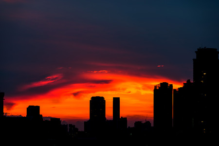 Urban city sunset silhouette with sky scrapers. Taken in Bangkok, Thailand during sunset time.の写真素材