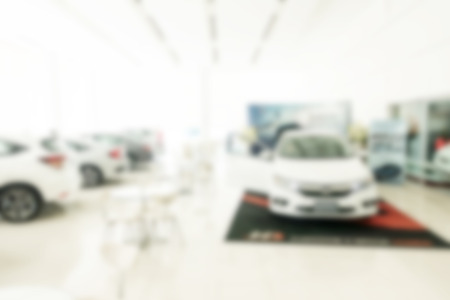 Blur background of car dealership showroom in white background. For car, automotive, dealer, showroom, shopping concepts.の写真素材