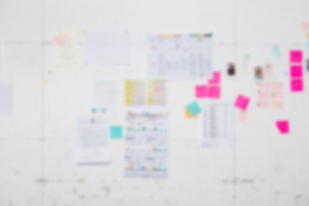 Blur background of white board with many business papers and reports stick on the white wall. With business report such as sale performance report, line chart, bar chart. For brain storming concept.の写真素材