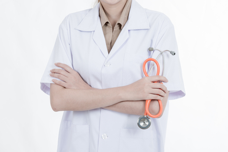Professional medical career concept. Young female doctor with stethoscope, white cloth isolated in white.の写真素材
