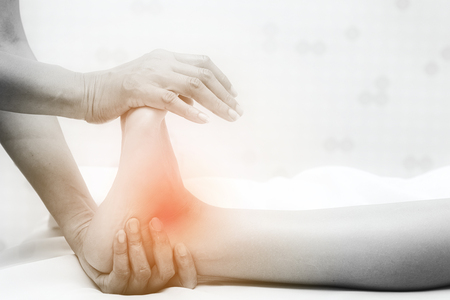 Asian exotic holiday spa concept. Beautiful young white woman enjoy relaxing during foot massage at spa, taken indoor in real spa location.の写真素材