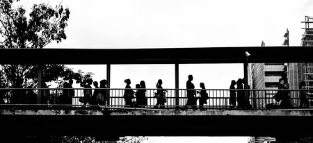 silhouette black and white citizen walking between nature and human stuctureの写真素材