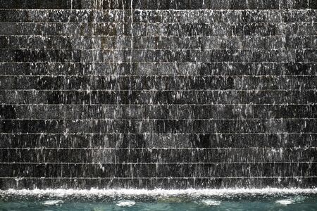 water fall on dark stone tileの写真素材