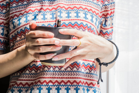 a girl holding cup of coffeeの写真素材