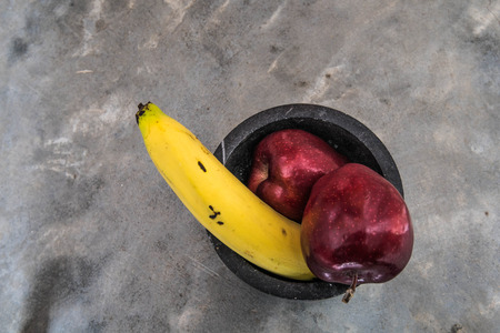 large banana and apples on strong concreteの写真素材