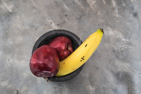 large banana and apples on strong concreteの写真素材