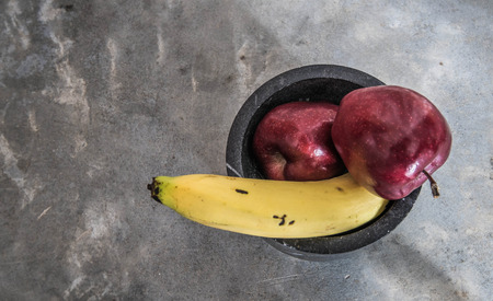 large banana and apples on strong concreteの写真素材