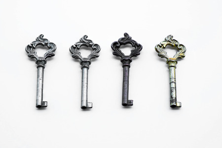 Arrange vintage keys on white background