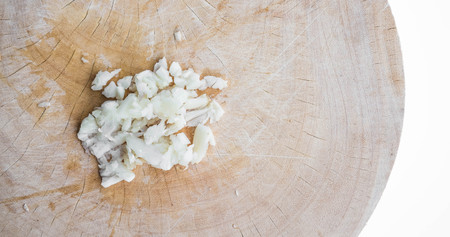 Slice and grid garlic on wooden blockの写真素材