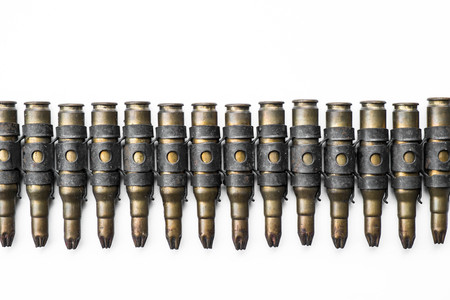 Old machine gun bullets on white backgroundの写真素材