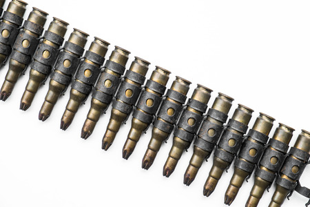 Old machine gun bullets on white backgroundの写真素材
