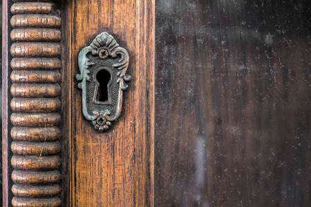 vintage wooden keyhole cabinet with white backgroundの写真素材