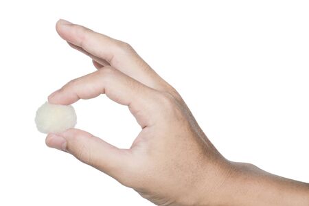 Male hand picking little fluffy ballの写真素材