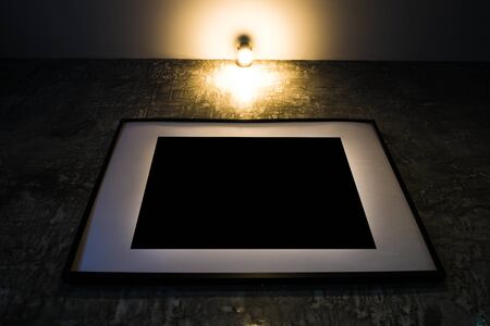 vintage tone, blank photo frame with glimmer retro yellow light on topの写真素材