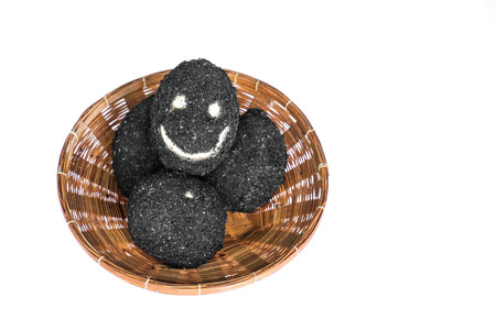 Salted eggs in rattan basket with happy faceの写真素材