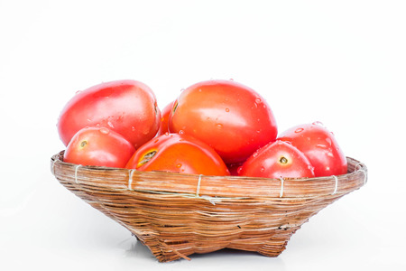 Fresh mini tomato in wooden rattan basket