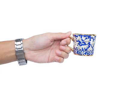 Hand holding classic luxury porcelain cup, isolated on white backgroundの写真素材
