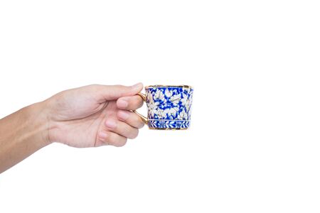 Hand holding classic luxury porcelain cup, isolated on white backgroundの写真素材
