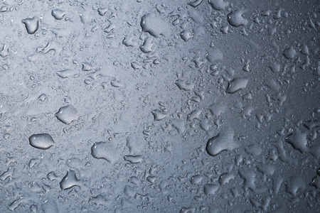 Water drop on shiny grey backgroundの写真素材
