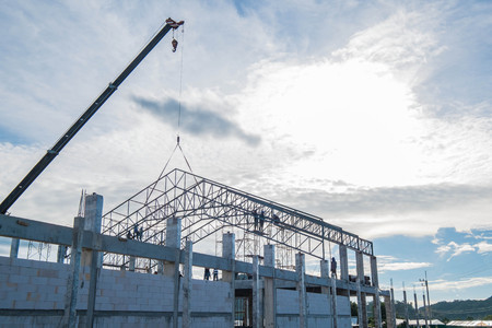 Under construction of roof's steel frame and concrete postの写真素材