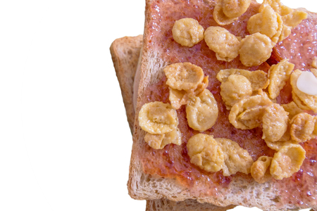 Toasted bread fill with strawberry jam and sweet cornflakes, isolated on white backgroundの写真素材