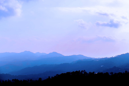 Silhouette mountains and coudの写真素材