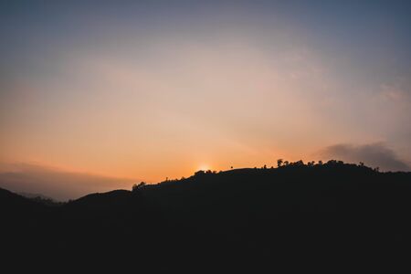 Silhouette mountains in sunsetの写真素材