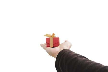 Hand holding, giving or receiving gift box, isolated on white backgroundの写真素材