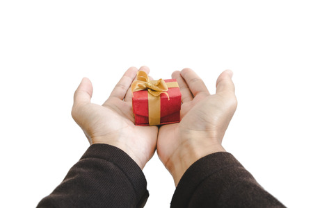 close-up hand holding, giving or receiving gift box, isolated on white backgroundの写真素材