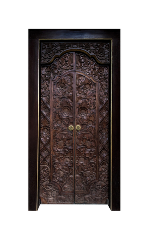 antique wooden door with wooden frame, isolated on black backgroundの写真素材