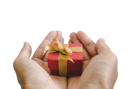 close-up hand holding, giving or receiving gift box, isolated on white backgroundの写真素材