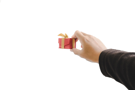 Hand holding, giving or receiving gift box, isolated on white backgroundの写真素材