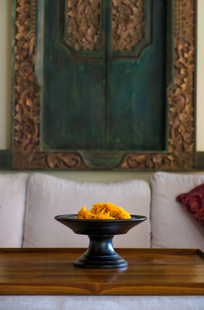 Flower on tray with sofa and pillow backgroundの写真素材