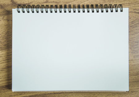 Notebook on wooden deskの写真素材