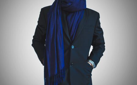 A man in casual suit with dark blue neck scarfの写真素材